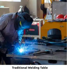 Worker welding on a Demmeler table in a workshop