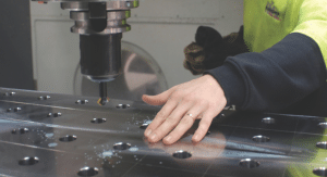 Close-up shot of engineer using a CNC machine