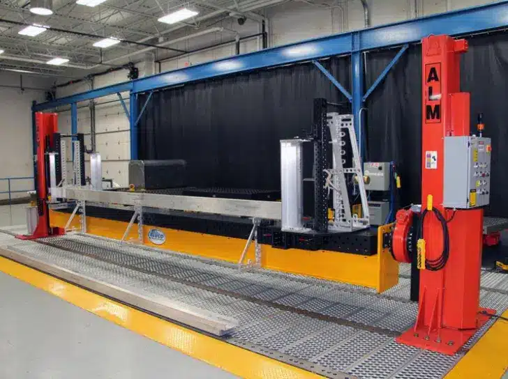 ALM dual-column welding positioner for long beam assembly in a fabrication facility