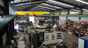 Elevated view of a Leussink engineering workshop showing a Zayer Memphis 4000U CNC bed mill in the foreground, with an Ellbeck ABUS overhead crane, multiple machines, racking, and workers visible throughout the facility