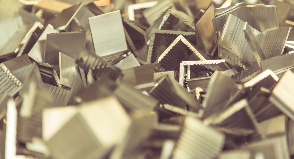 A pile of small cut aluminium or steel angle section offcuts and metal scrap pieces.