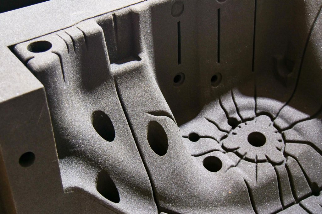 Close-up of a complex sand core with intricate channels and cavities, produced using precision core making equipment for casting applications.