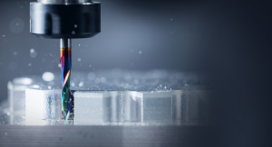 Close-up of CNC drill bit cutting into metal workpiece with coolant spray