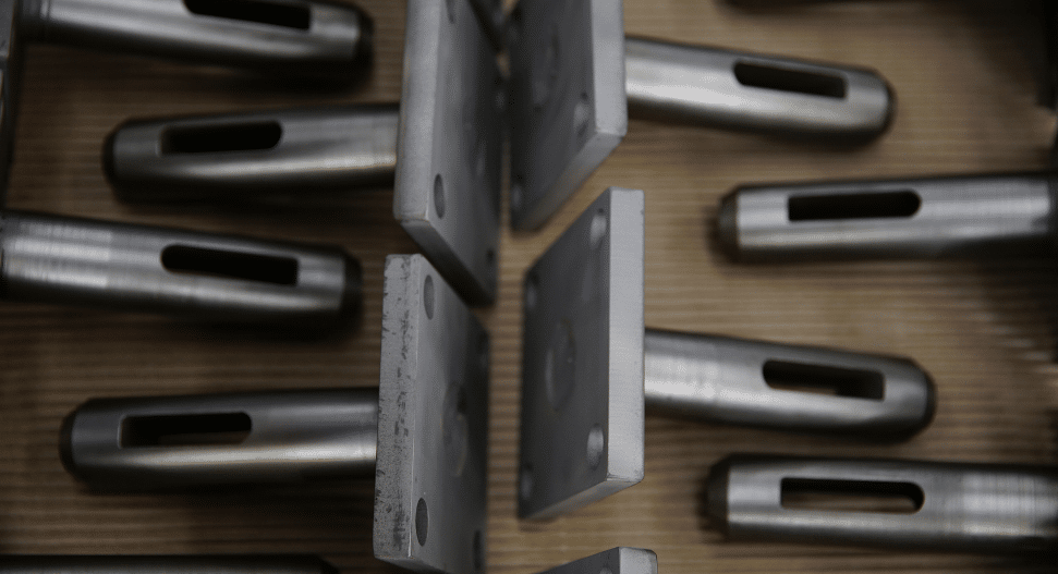 Short-run batch of small CNC machined steel components with milled slots